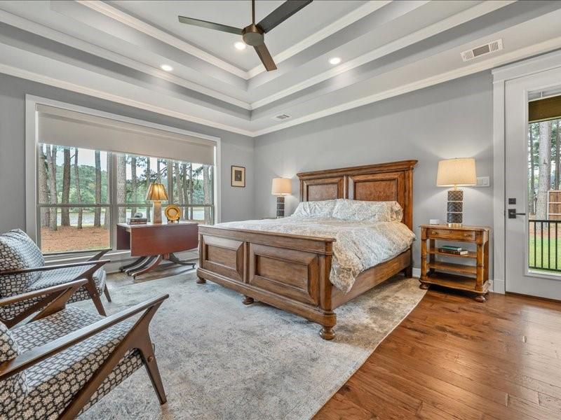 8595 Toler Pointe Larue, TX 75770 - Photo 25 of 40 Spacious Primary Bedroom with incredible views of the lake. The full moon rises on this side and you see it through the pines. Side patio access for dogs or just to enjoy a quiet moment. Auto shades.