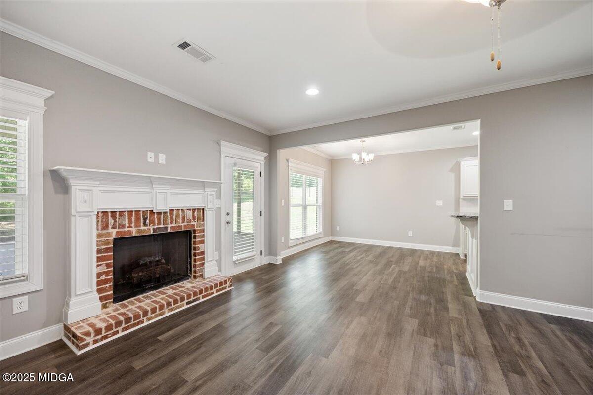 14 Carters Way Forsyth, GA 31029 - Photo 6 of 23 a view of an empty room with wooden floor fireplace and a window