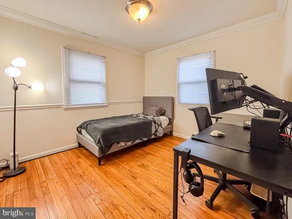 a bedroom with furniture and a wooden floor