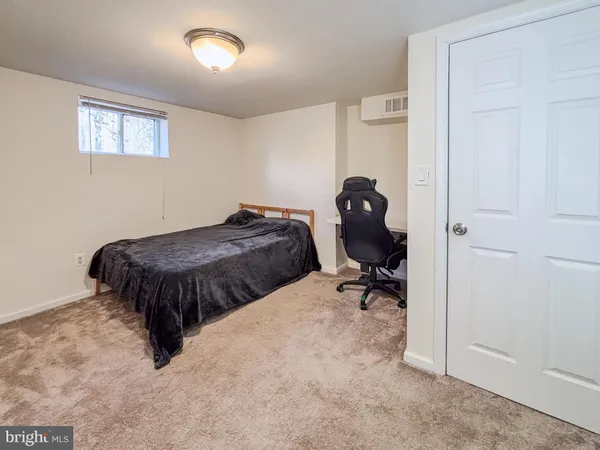 a bedroom with a bed and table chair