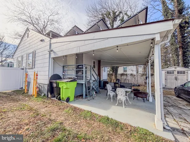 a view of a patio with dining table and chairs