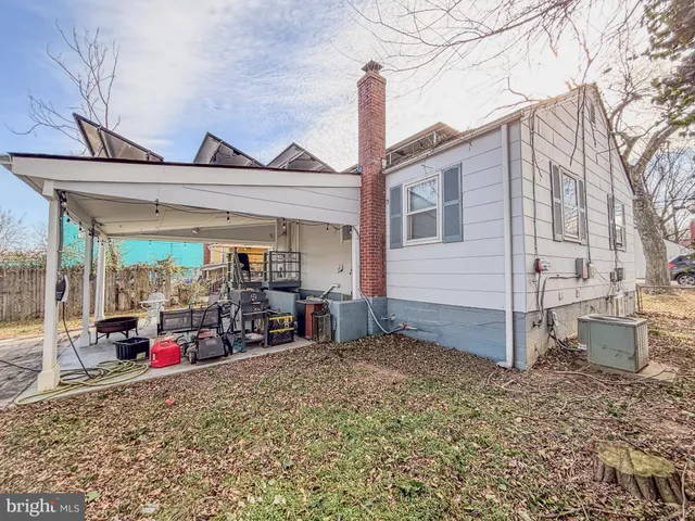 a front view of a house with a yard covered with snow