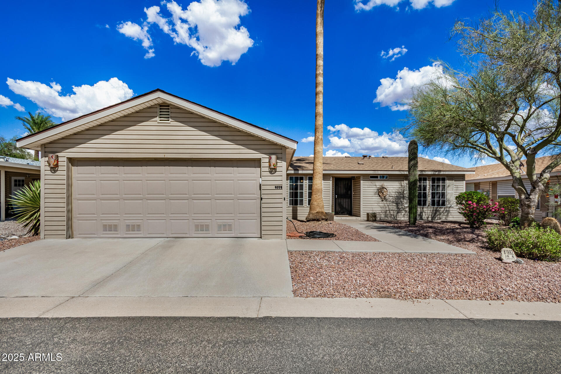 a front view of a house with a yard and a garage