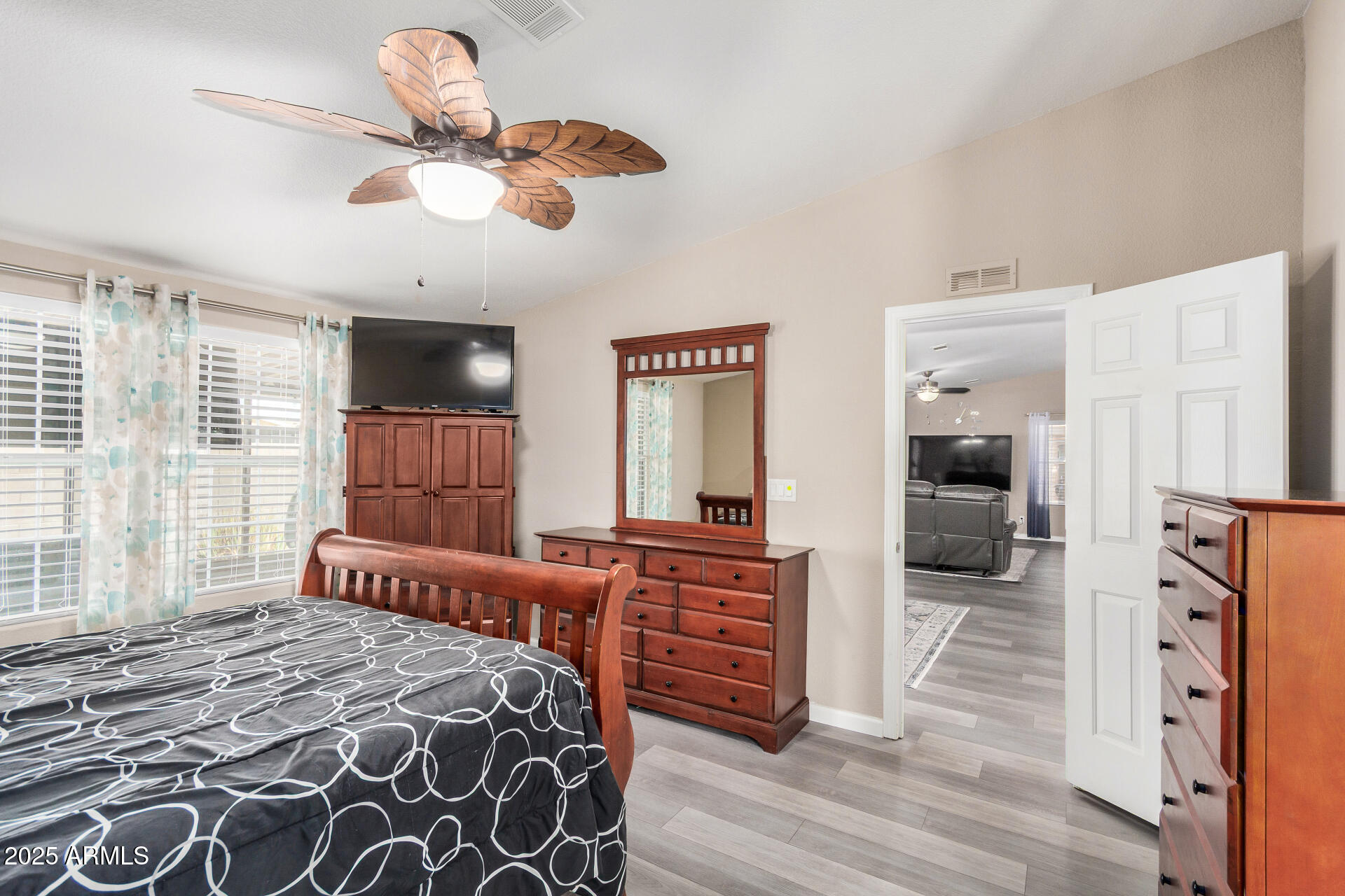 3301 South Goldfield Road, Unit 1002 Apache Junction, AZ 85119 - Photo 11 of 25 a bedroom with furniture and a large window