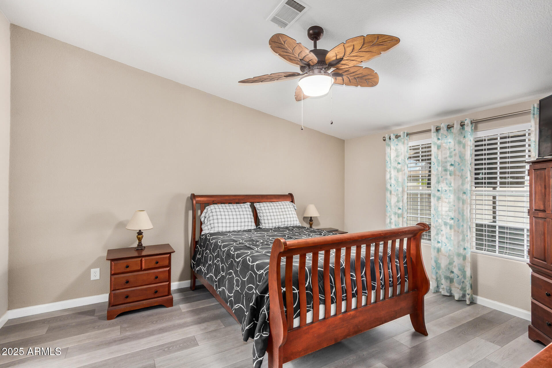 3301 South Goldfield Road, Unit 1002 Apache Junction, AZ 85119 - Photo 12 of 25 a bedroom with a bed and a chandelier
