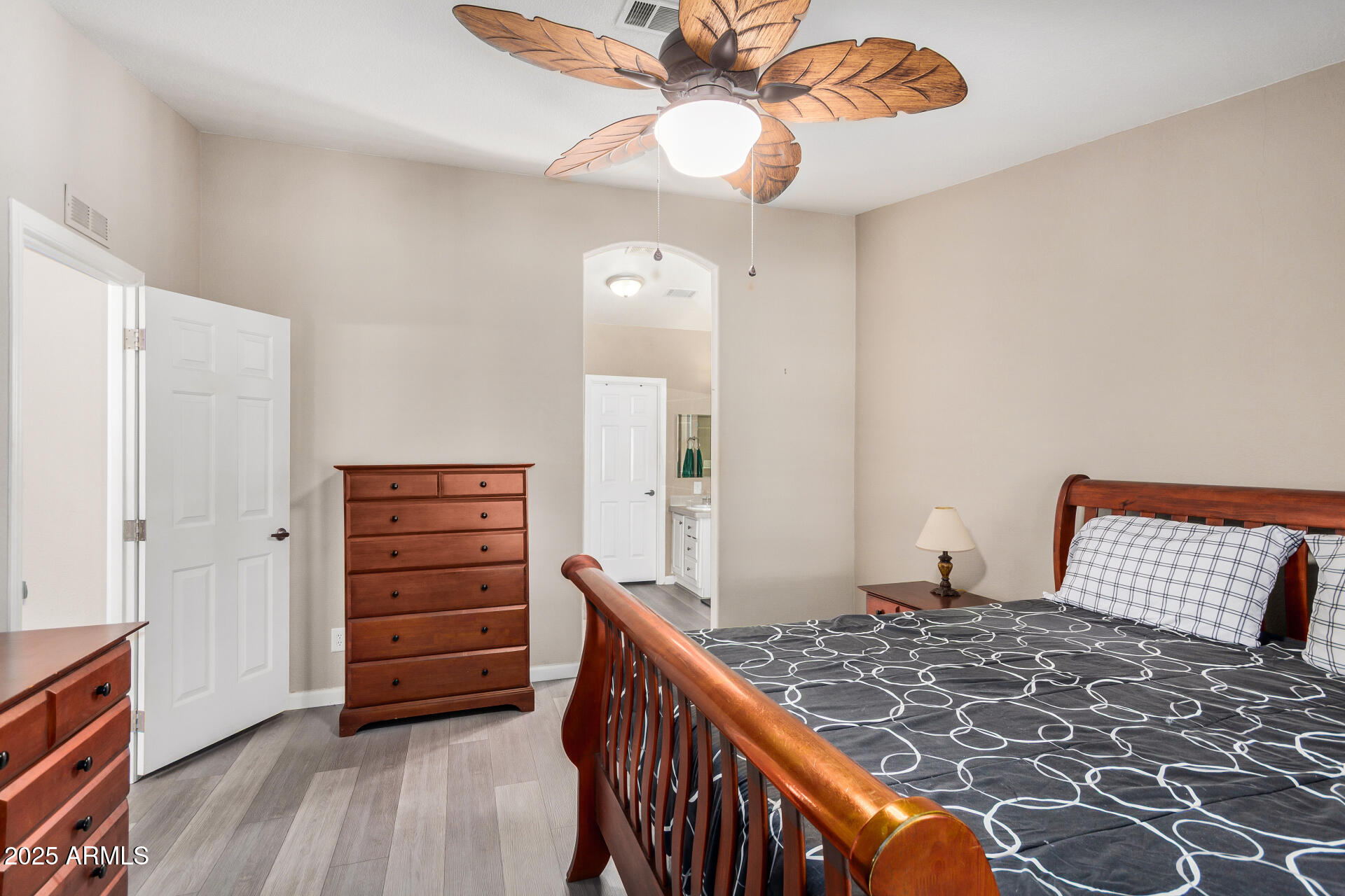 3301 South Goldfield Road, Unit 1002 Apache Junction, AZ 85119 - Photo 13 of 25 a bedroom with a bed and wooden floor