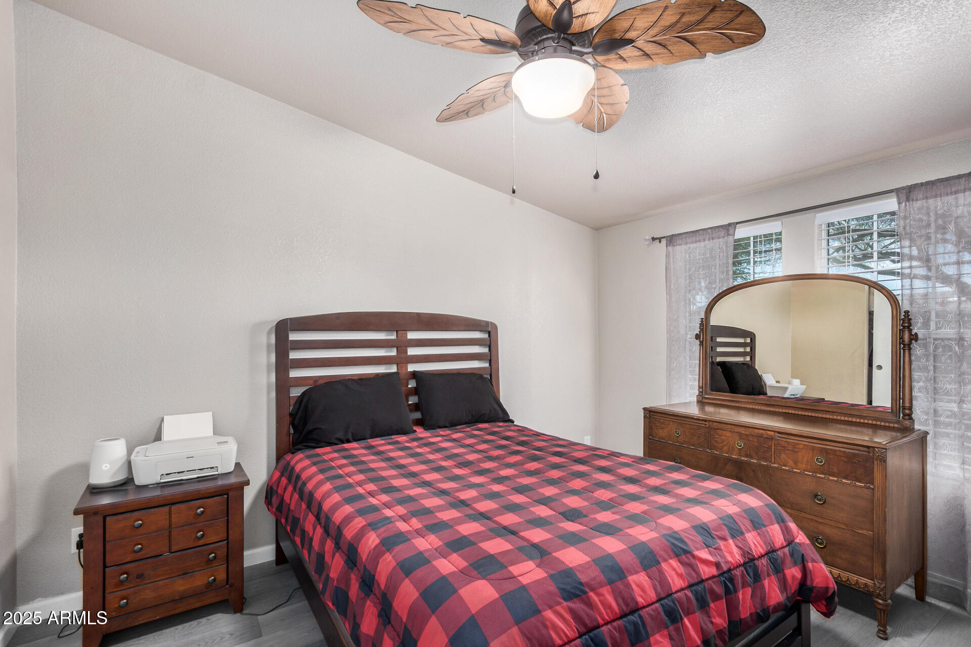 3301 South Goldfield Road, Unit 1002 Apache Junction, AZ 85119 - Photo 17 of 25 a bedroom with a bed and a chandelier