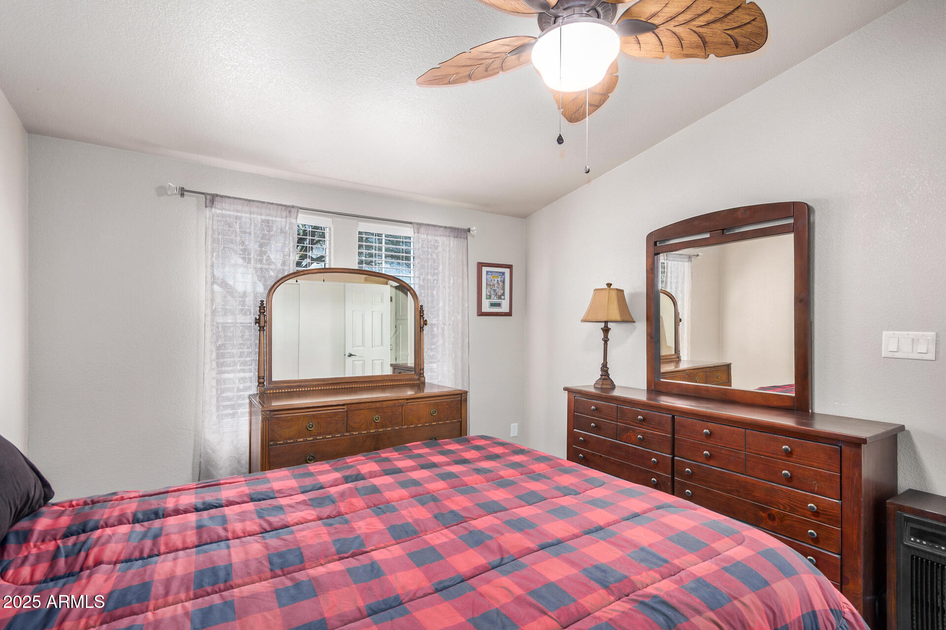 3301 South Goldfield Road, Unit 1002 Apache Junction, AZ 85119 - Photo 18 of 25 a bedroom with a bed and a dresser with mirror