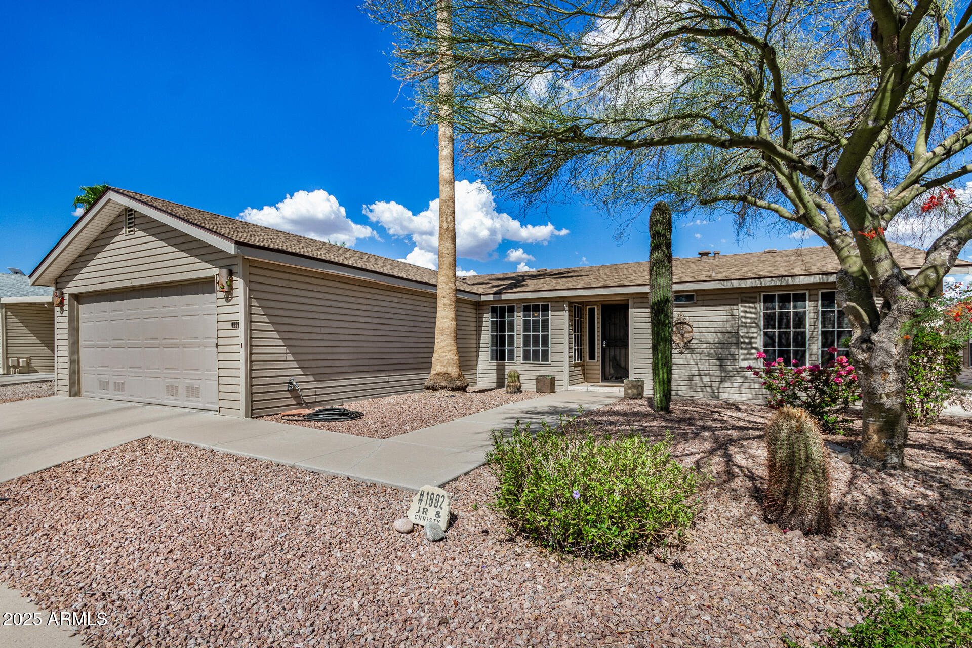 3301 South Goldfield Road, Unit 1002 Apache Junction, AZ 85119 - Photo 2 of 25 a front view of house with a garden