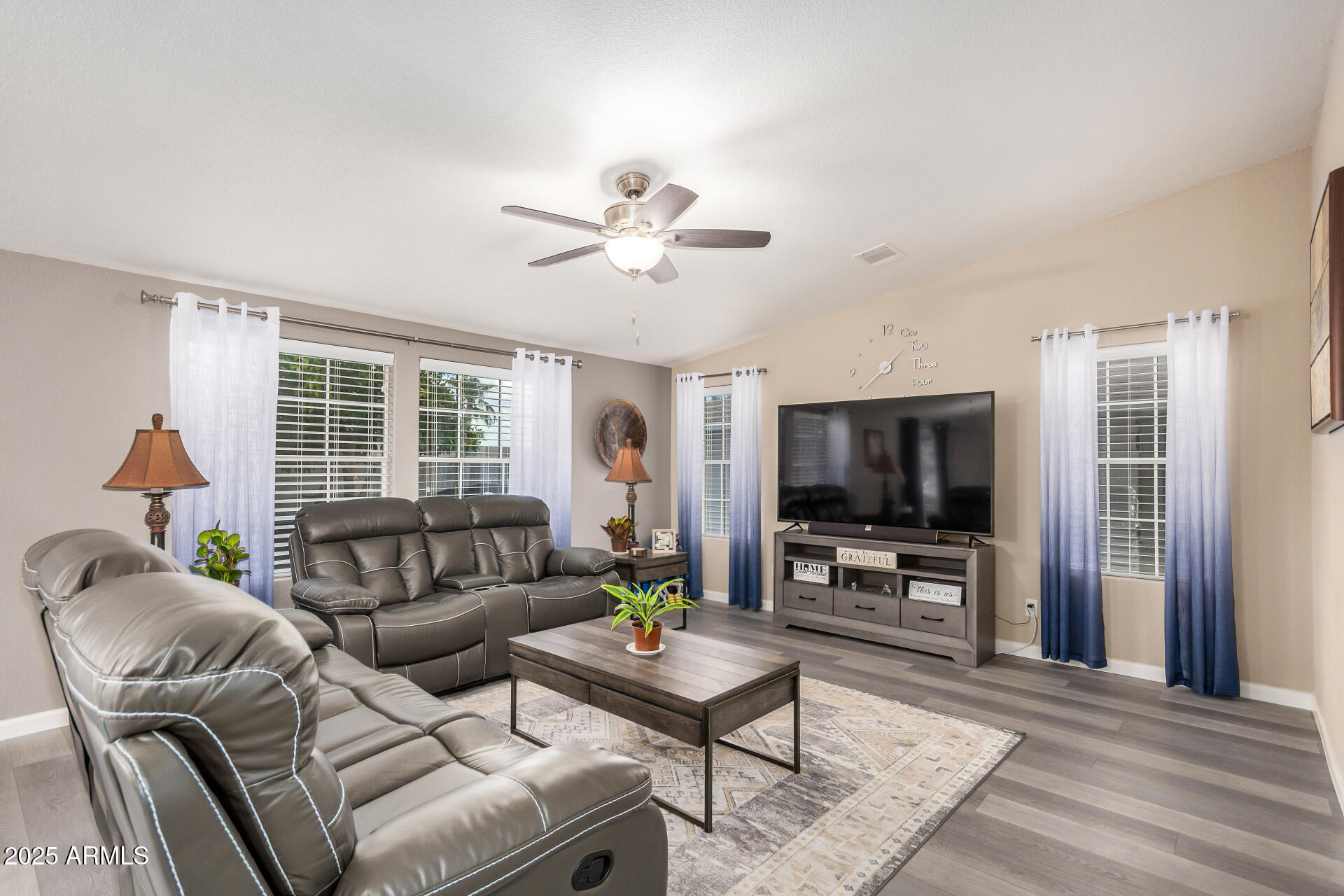 3301 South Goldfield Road, Unit 1002 Apache Junction, AZ 85119 - Photo 3 of 25 a living room with furniture and a flat screen tv
