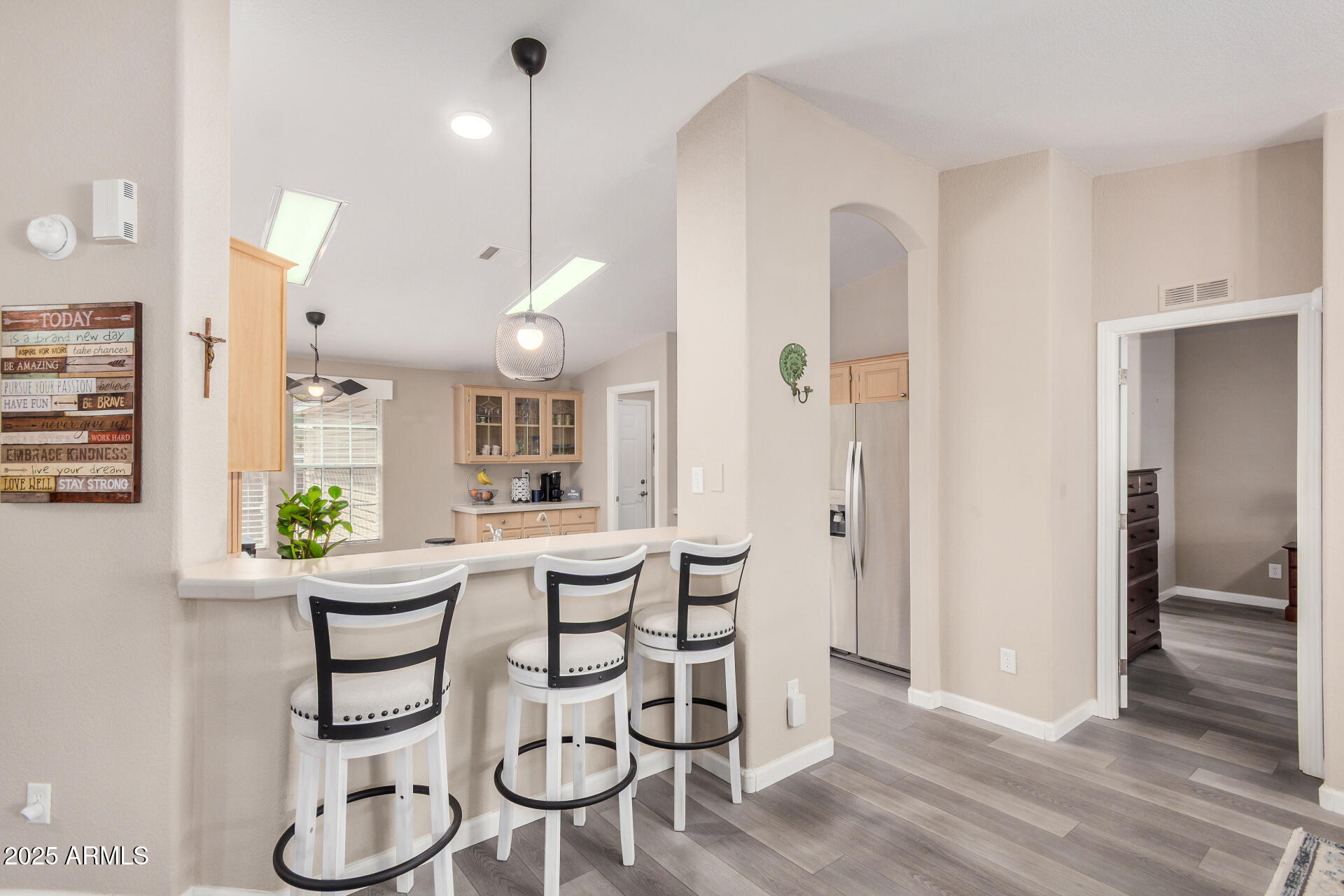 3301 South Goldfield Road, Unit 1002 Apache Junction, AZ 85119 - Photo 7 of 25 a room with stainless steel appliances a table chairs and entryway