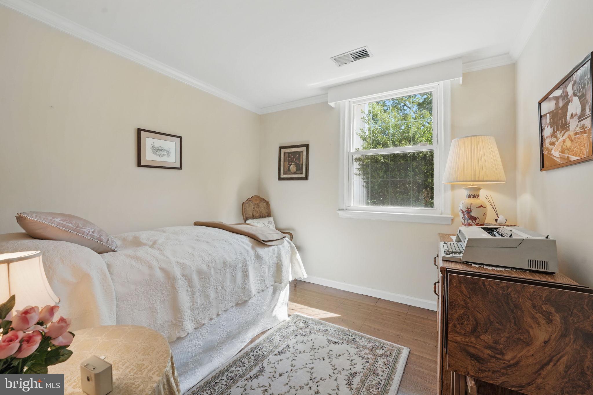 4602 Old Mill Road Alexandria, VA 22309 - Photo 13 of 46 a bedroom with a bed and window