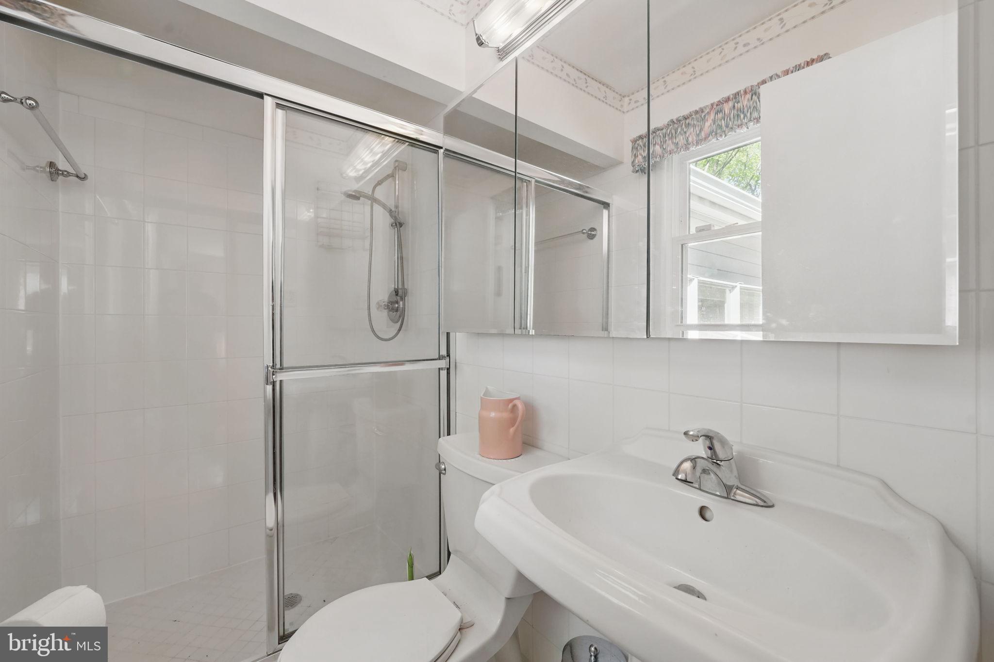 4602 Old Mill Road Alexandria, VA 22309 - Photo 24 of 46 a bathroom with a sink toilet and shower