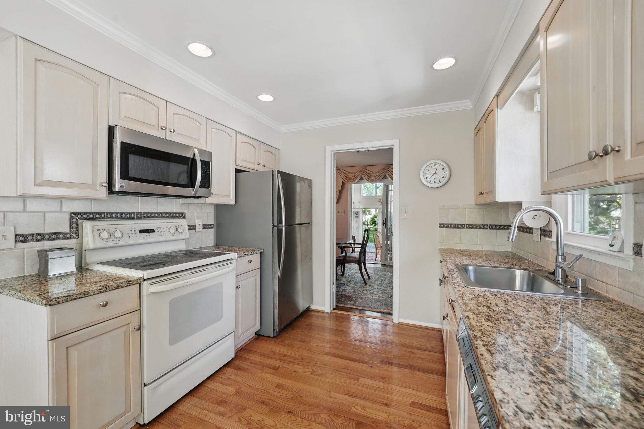 4602 Old Mill Road Alexandria, VA 22309 - Photo 32 of 46 a kitchen with a stove a sink and a microwave