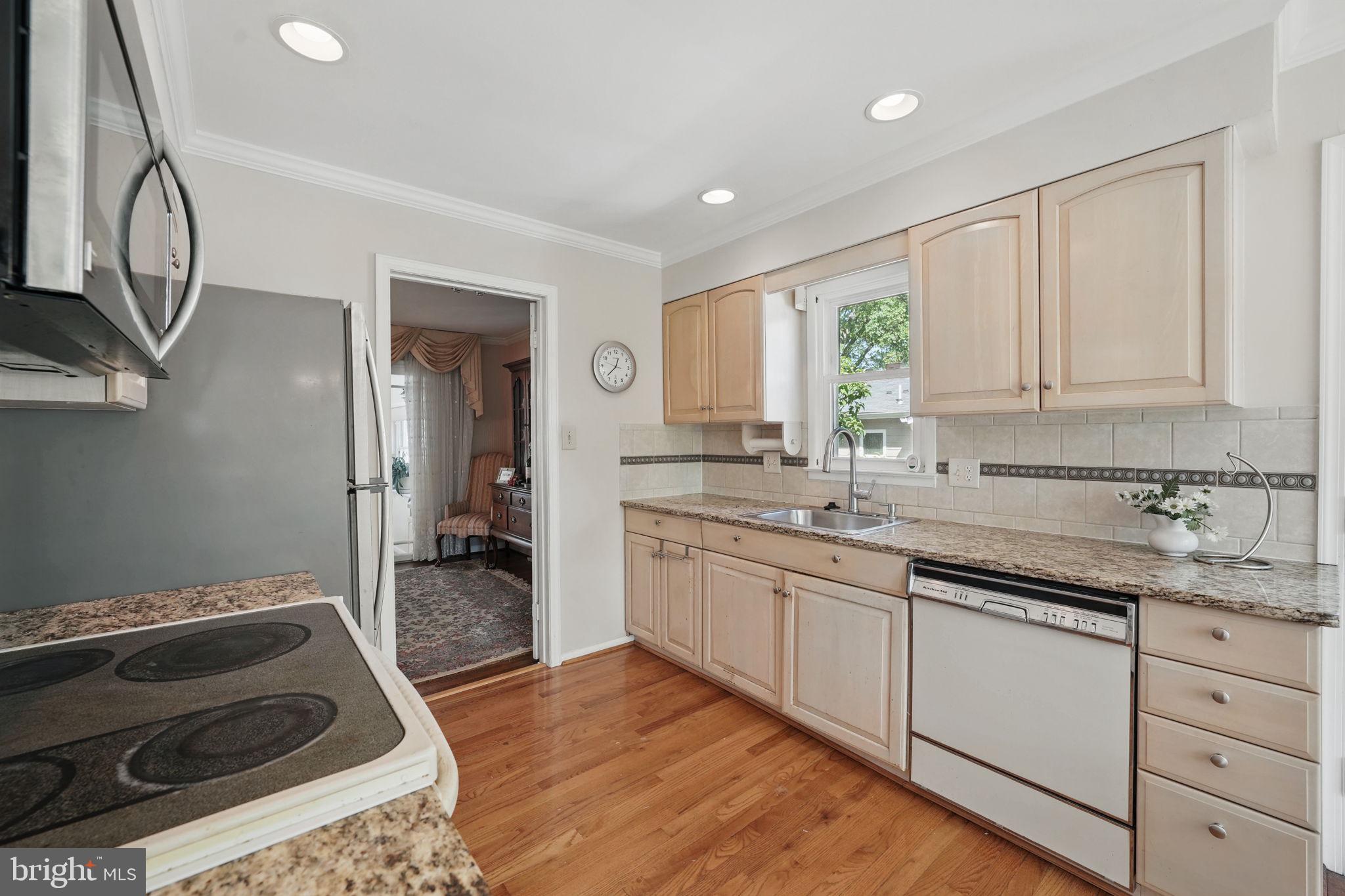 4602 Old Mill Road Alexandria, VA 22309 - Photo 33 of 46 a kitchen with granite countertop a sink stainless steel appliances and cabinets