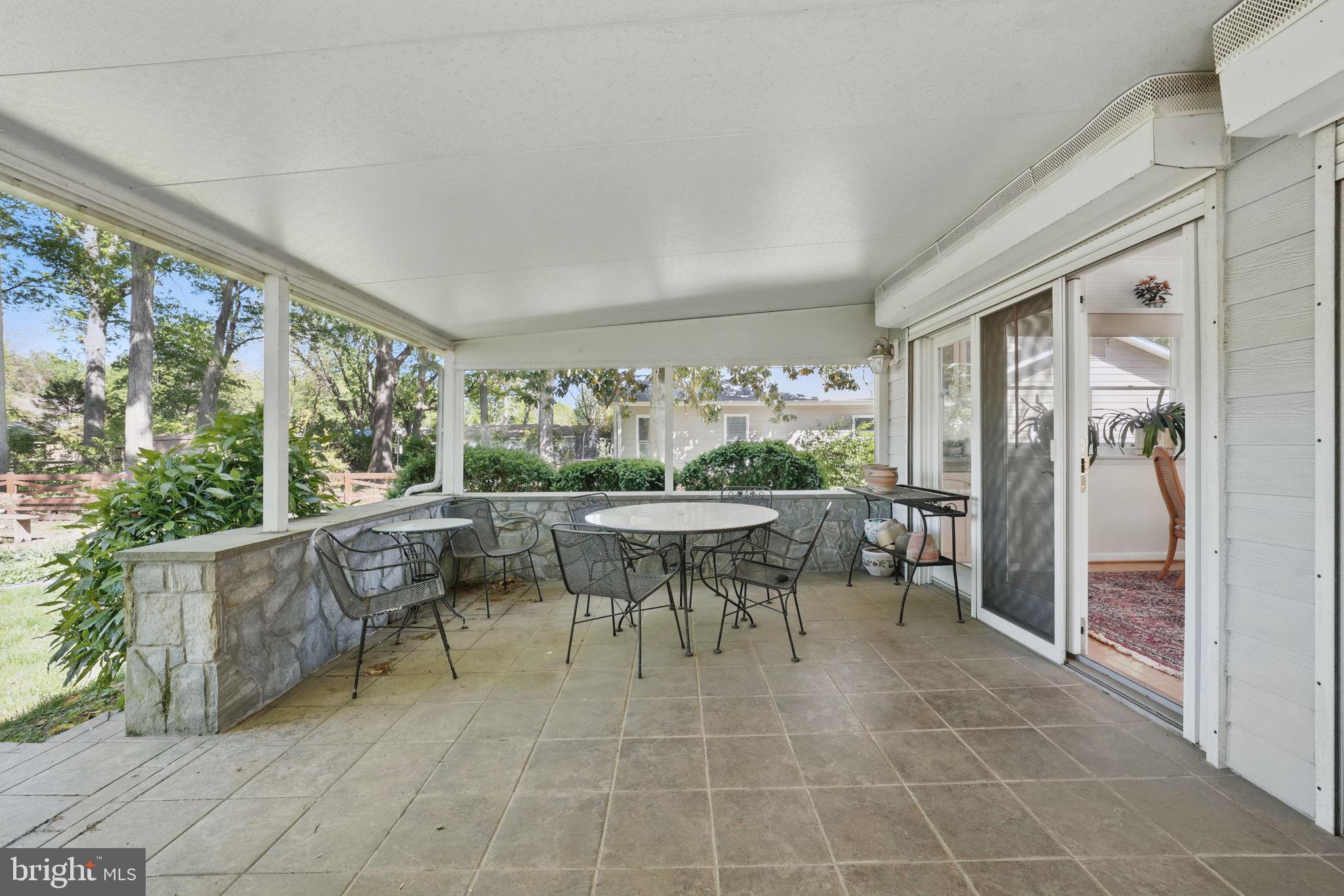 4602 Old Mill Road Alexandria, VA 22309 - Photo 39 of 46 a view of a patio with table and chairs and potted plants
