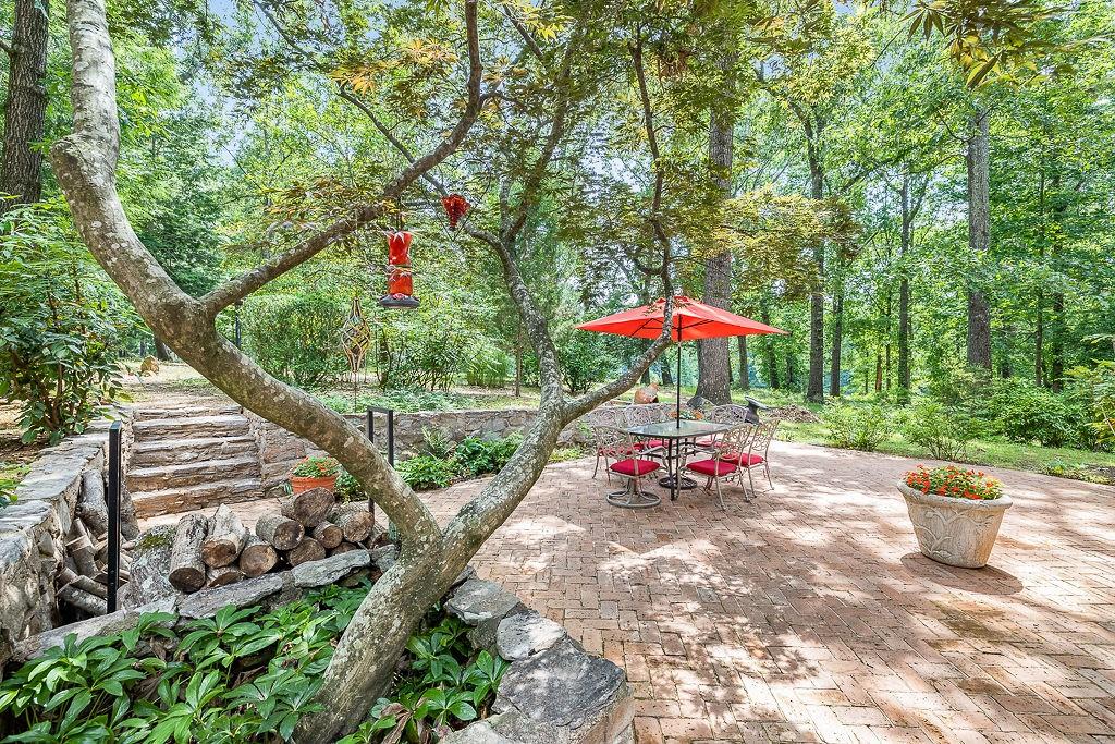 8569 Jefferson Road Commerce, GA 30529 - Photo 16 of 82 a view of a table and chairs under an umbrella with wooden fence