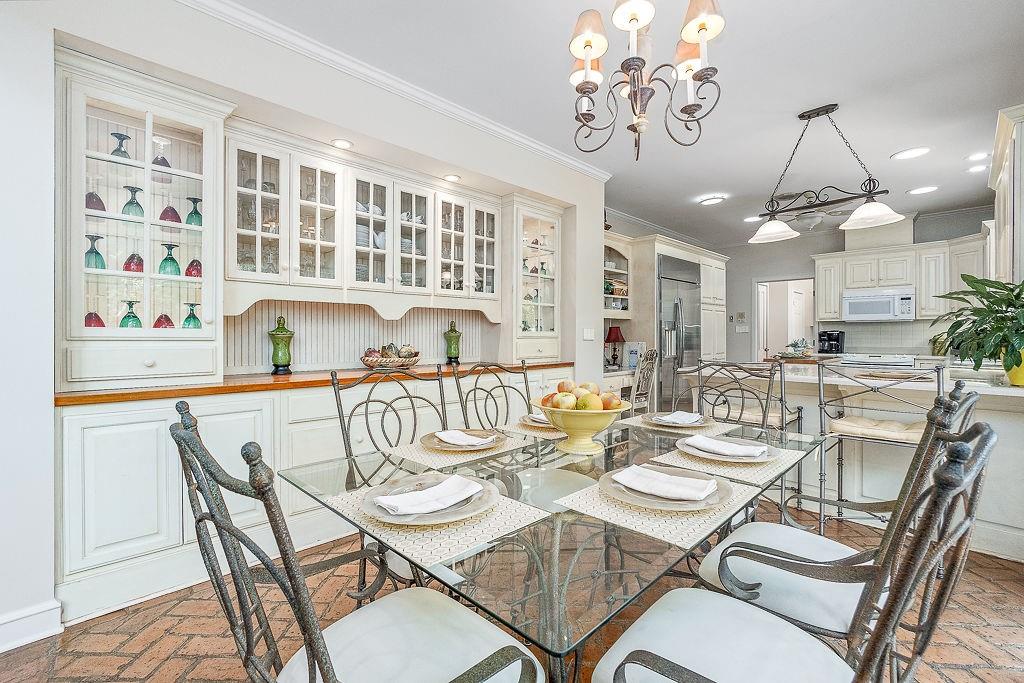 8569 Jefferson Road Commerce, GA 30529 - Photo 18 of 82 a view of a dining room with furniture a chandelier and wooden floor