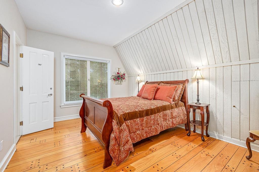 8569 Jefferson Road Commerce, GA 30529 - Photo 43 of 82 a bedroom with a bed and wooden floor