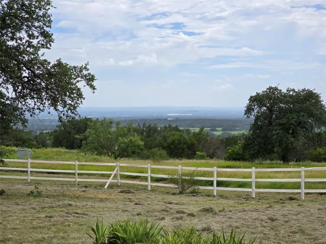 a view of a field with an trees