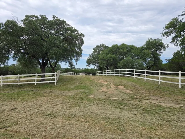 a view of a field with an trees