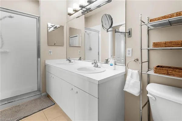 a view of a hallway with wooden floor and a large mirror