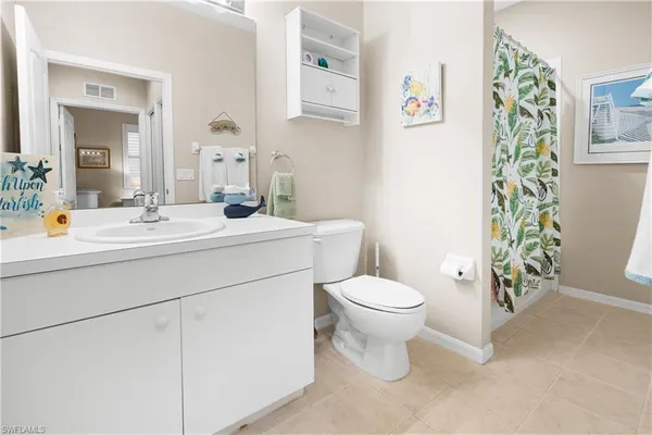 a kitchen with a refrigerator stove and white cabinets