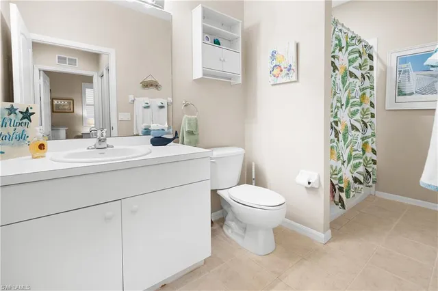 a kitchen with a refrigerator stove and white cabinets