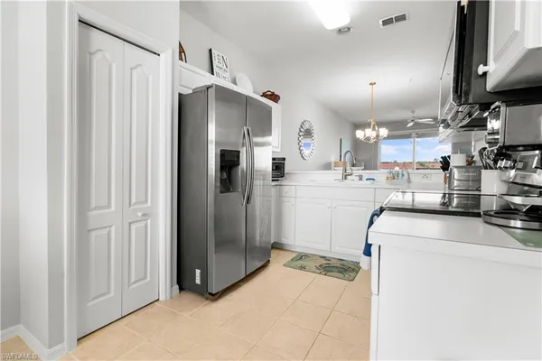a view of a dining room with furniture a chandelier and wooden floor