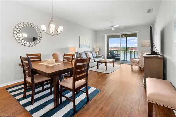 a bedroom with a bed and a dresser next to a window
