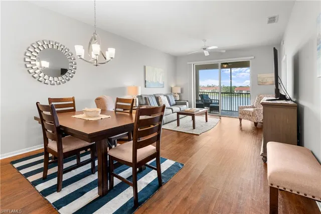 a bedroom with a bed and a dresser next to a window