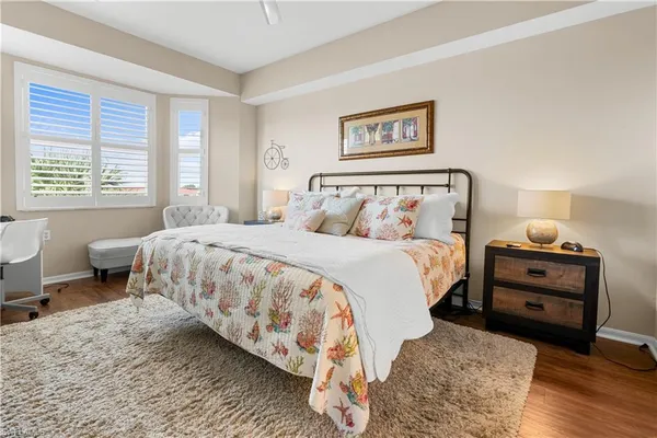 a bedroom with a bed and a flat screen tv on dresser