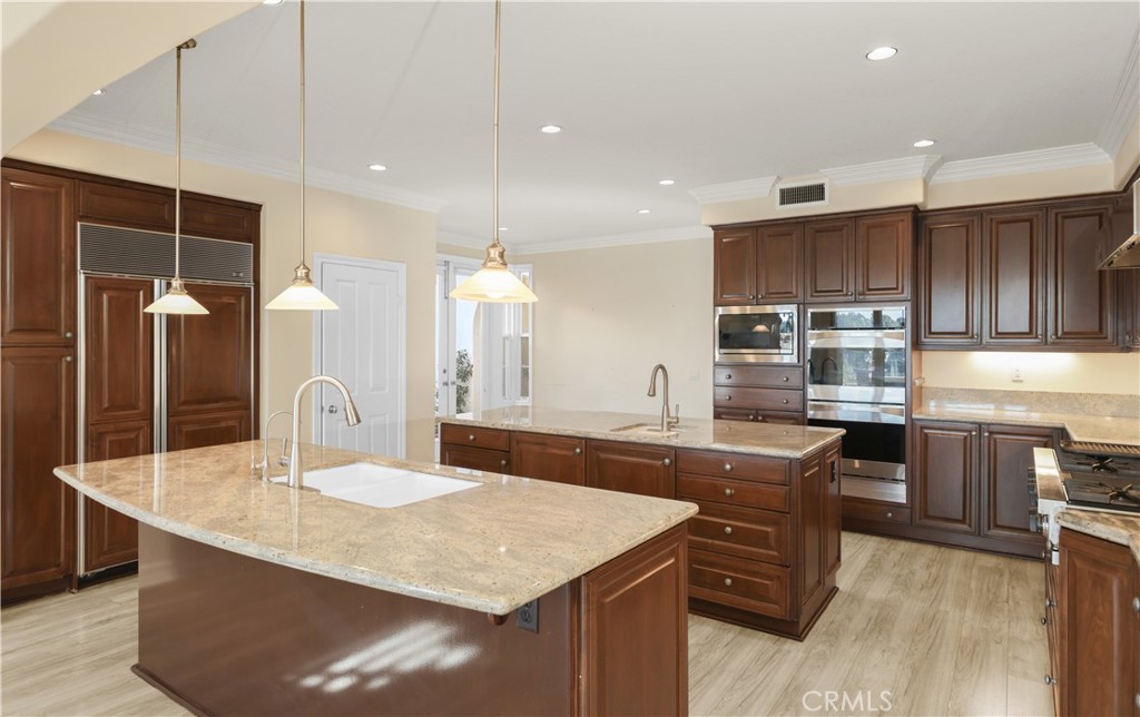 18 Vernon Newport Coast, CA 92657 - Photo 12 of 52 a kitchen with kitchen island granite countertop a sink and counter space