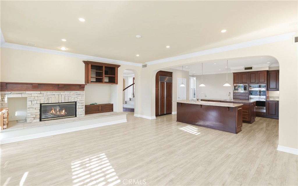 18 Vernon Newport Coast, CA 92657 - Photo 16 of 52 a large kitchen with stainless steel appliances kitchen island granite countertop a large counter top and a fireplace