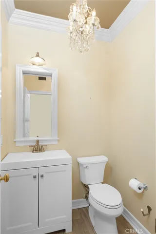 a bathroom with a sink vanity mirror and toilet