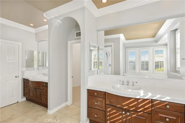 a bathroom with a granite countertop sink and a bathtub