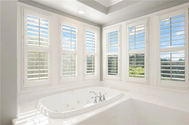 a bath tub sitting in a bathroom next to a window