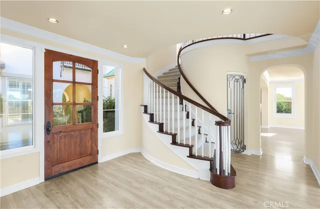 a view of an entryway with wooden floor and windows