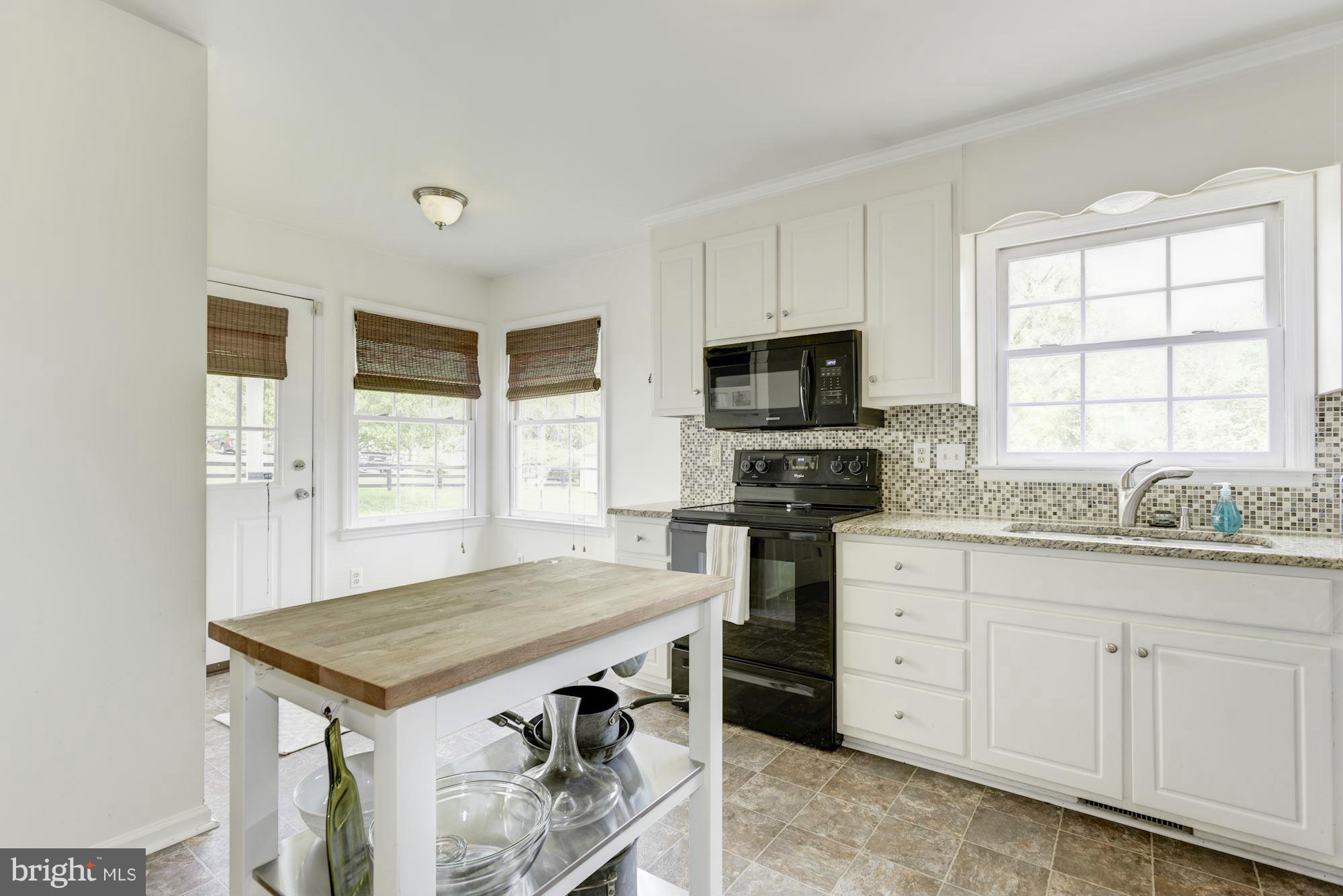 17 New Cut Road Round Hill, VA 20141 - Photo 12 of 29 a kitchen with granite countertop a sink stove and cabinets