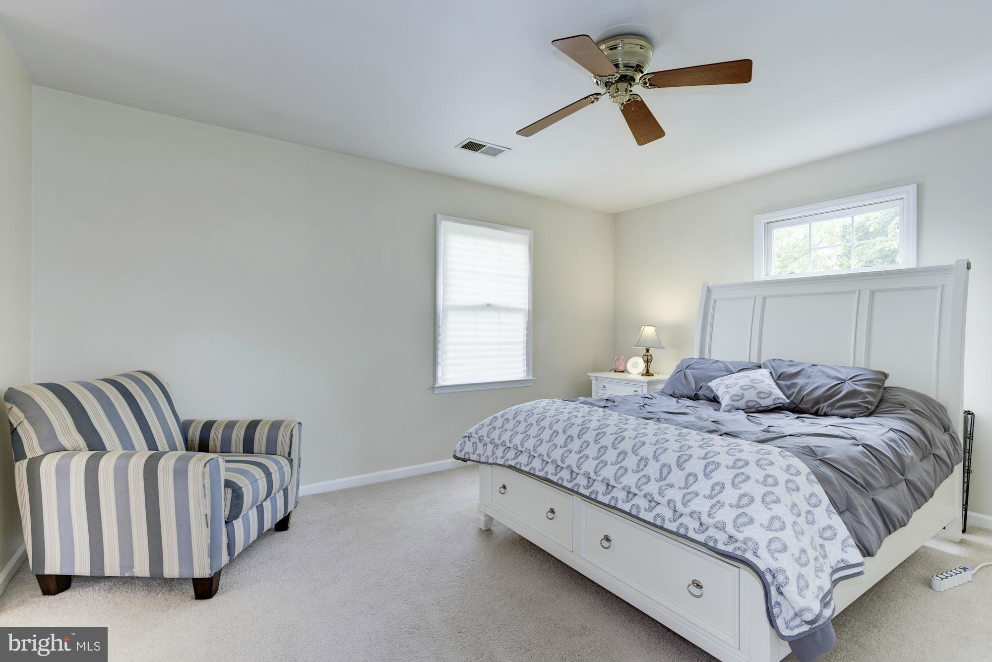 17 New Cut Road Round Hill, VA 20141 - Photo 13 of 29 a bedroom with a bed and a chandelier