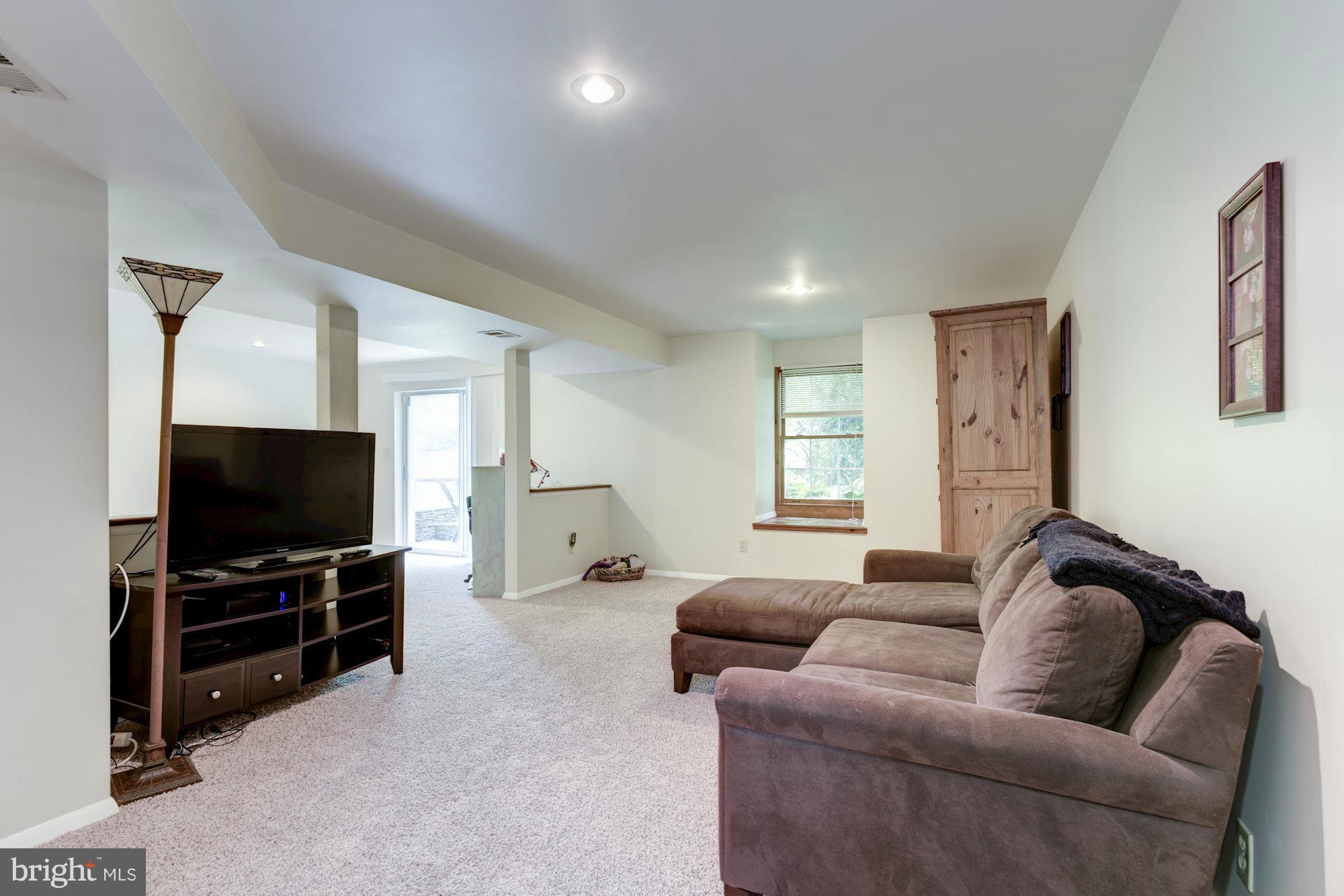 17 New Cut Road Round Hill, VA 20141 - Photo 21 of 29 a living room with furniture and a flat screen tv