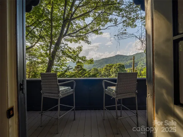 a balcony with table and chairs