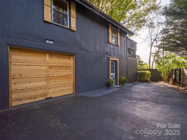 a view of a blue house with a outdoor space