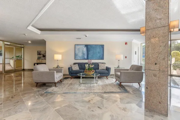 a room with lots of table chairs wooden floor and window