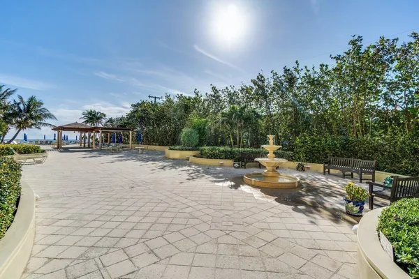 a front view of multi story residential apartment building with yard and green space