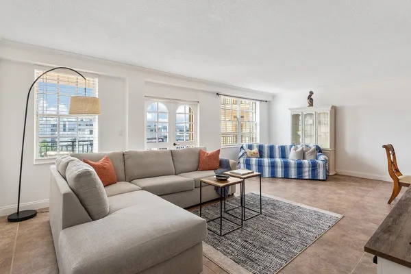 a living room with furniture rug and window