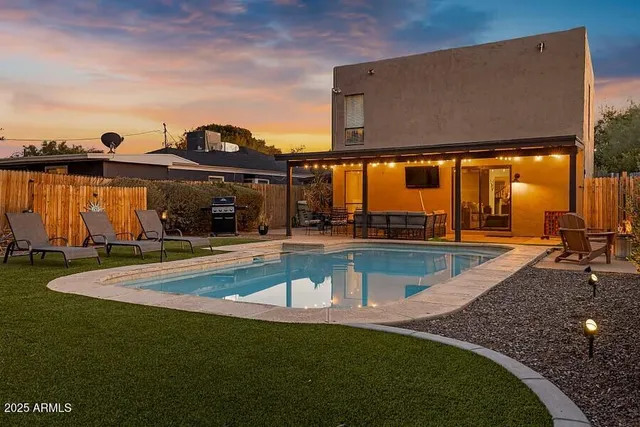 a view of a swimming pool with two chairs
