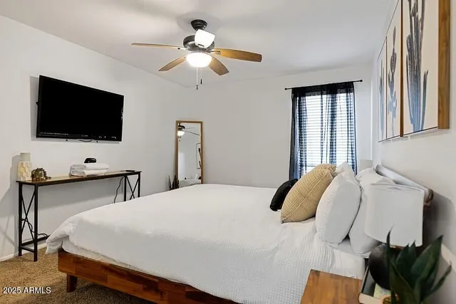 a bedroom with a bed and wall painting