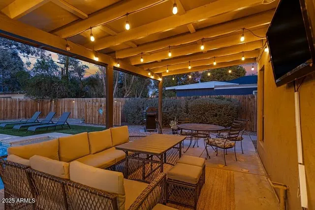 a kitchen with granite countertop a sink a counter top space appliances and dining room view