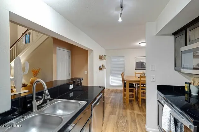 a kitchen with a sink stove and refrigerator